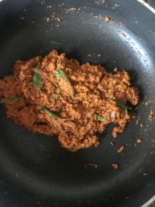 Frying the prepared masala paste with the onions